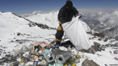 A Sherpa collects rubbish on Mount Everest