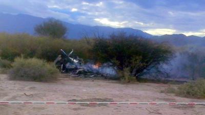 Picture of the burning wreckages of two helicopters which collided mid-air near Villa Castelli, in the Argentine province of La Rioja on 9 March 2015