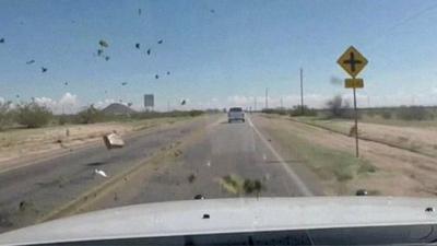 Arizona police dash-cam footage of high speed pursuit, as large bales of marijuana are thrown from the car being chased