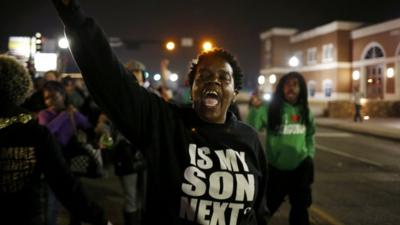 A protestor shouts during a demonstration outside the Ferguson Police Department in Ferguson, Missouri