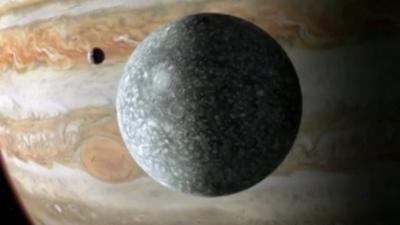 Ganymede foreground, Jupiter in backgrond
