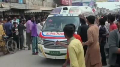 An Ambulance leaves the scene in Lahore