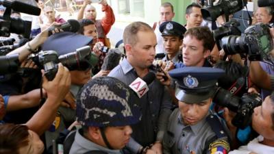 New Zealand citizen Philip Blackwood (C), escorted by Myanmar policemen as he comes out from court after being sentenced two and a half years in prison