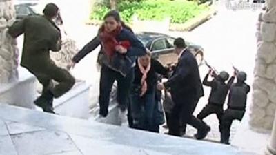 Image taken from video shows tourists running for cover as armed men stand guard at Tunisia's national museum in Tunis