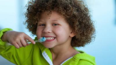 Child brushing her teeth