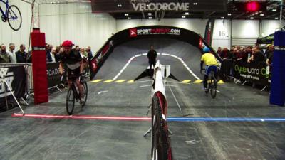 People cycling inside velodrome