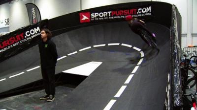 People cycling inside velodrome