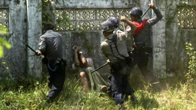 Police officers beat a man