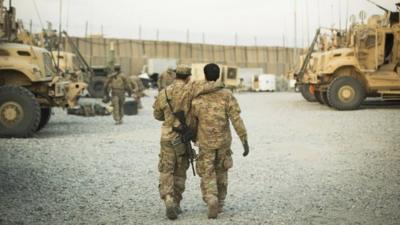 A US soldier from the 3rd Cavalry Regiment walking with the unit's Afghan interpreter