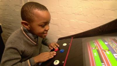 William plays arcade game