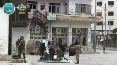 Holding a flag in Idlib