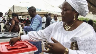 A woman casts her ballot at a polling station in Lagos