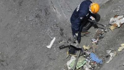 Rescue worker inspects crash site of flight 4U 9525