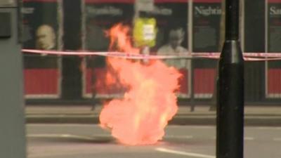 Plume of flame from under the ground in Holborn, London