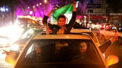 Iranians celebrate on a street in northern Tehran, Iran, after Iran's nuclear agreement with world powers