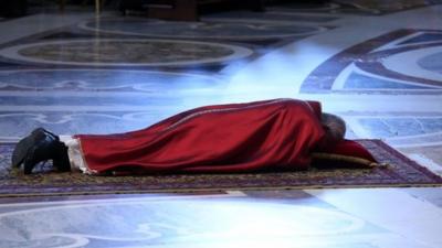Pope Francis lies in prayer