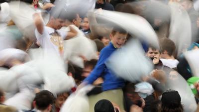 Revellers take part in a giant pillow fight in Trafalgar Square on 'International Pillow Fight Day' on April 4, 2015 in London, England.