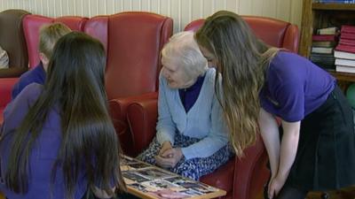 School pupils visit a resident in a care home