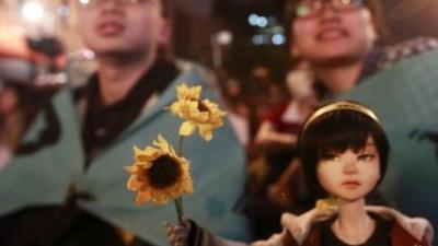 Activists mark the one-year anniversary of the start of the Sunflower Movement outside the Legislative Yuan in Taipei March 18, 2015