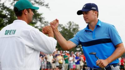 Jordan Spieth fists bumps caddie