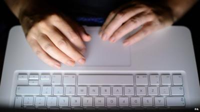 Person using a laptop keyboard