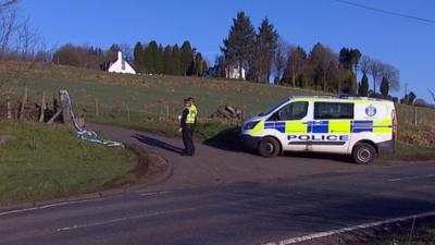 Police search a farm