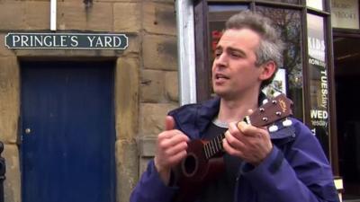 Man sings a song to David Cameron