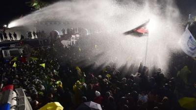 Protesters sprayed with a water cannon by police at a rally in Seoul, held to remember the Sewol ferry disaster victims