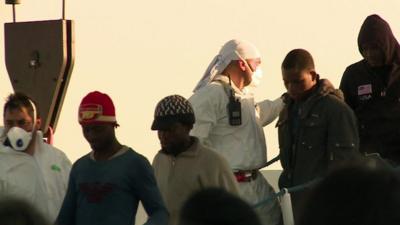 Migrants walking from boat