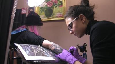 Tattoo artist working