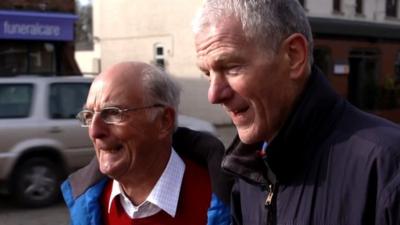 Two older men are poised ready to race each other