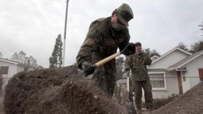 Soldiers help clean up following volcano eruption