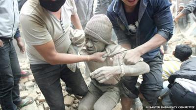 A man being pulled out of rubble