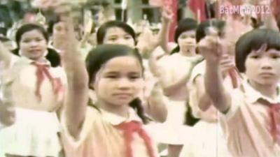 Archive picture of Vietnamese children waving flags