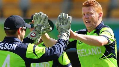 Kevin O'Brien (right) celebrates taking a wicket