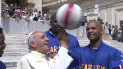 Pope Francis plays with a basketball