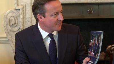 David Cameron with a copy of the Conservative election manifesto