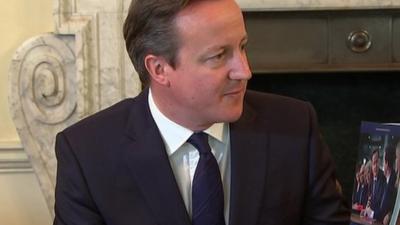 David Cameron with a copy of the Conservative election manifesto