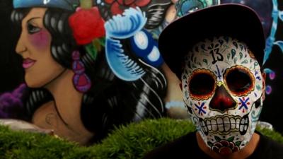 artist wearing skull mask