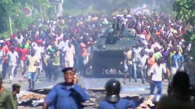 Crowds in Bujumbura surrounding a tank as they celebrate news of the overthrow of President Nkurunziza