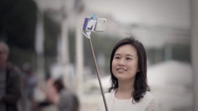Woman with selfie stick