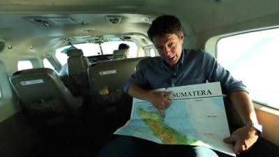 Ian Pannell in plane pointing at map of area