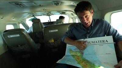 Ian Pannell in plane pointing at map of area