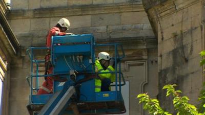 Engineers examine the building