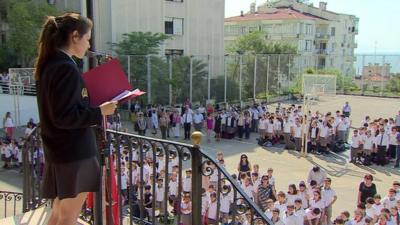 Student reading to school pupils