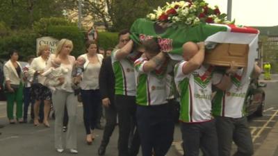 Danny Jones' family follow his coffin