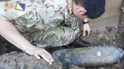 Soldier looking at bomb discovered in Wembley, north London