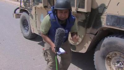 Omar Abdel-Razek next to armoured vehicle