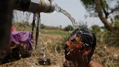 An Indian man takes bath