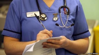 Nurse writing up notes